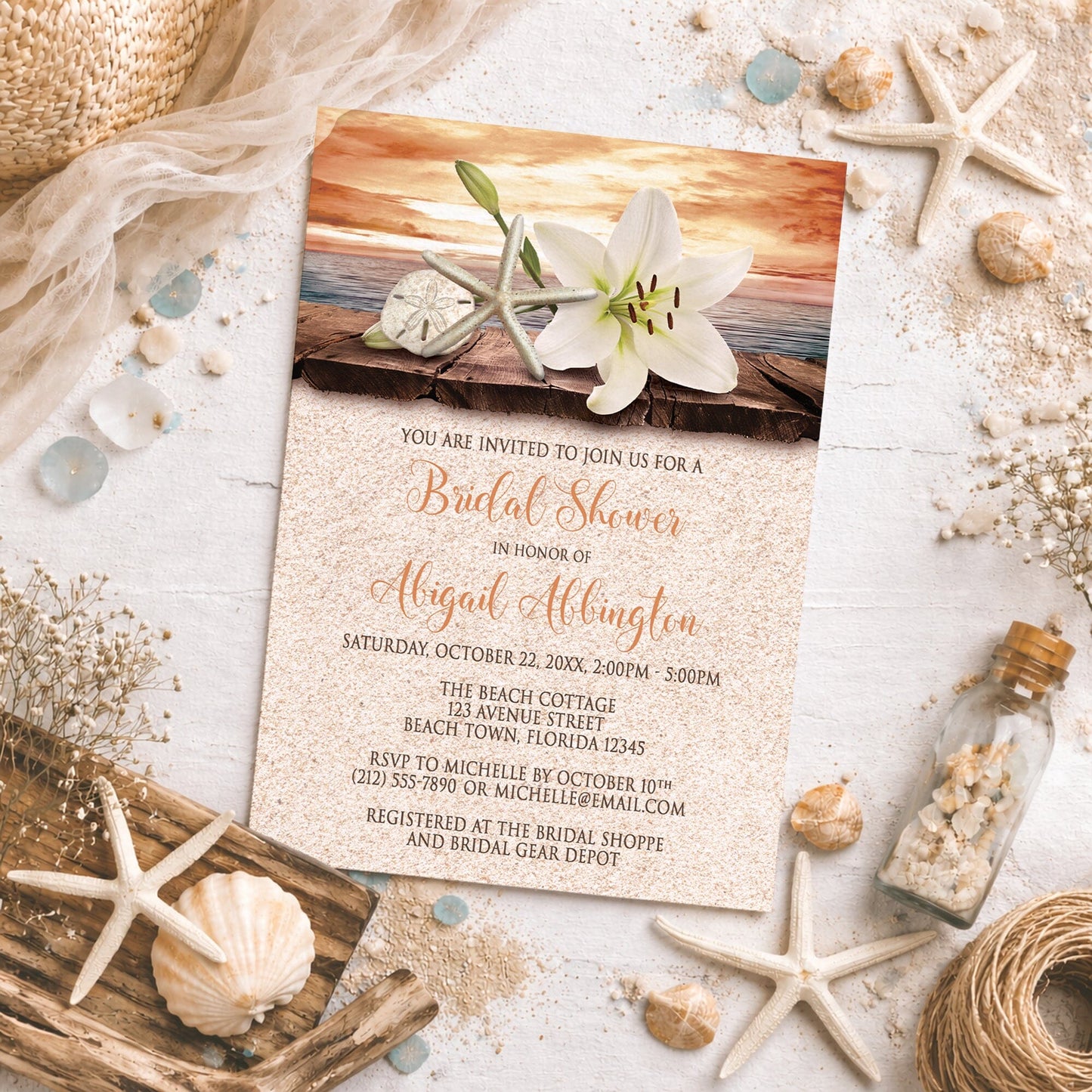 Lily Seashells and Sand Autumn Beach Bridal Shower Invitation on a sandy background.