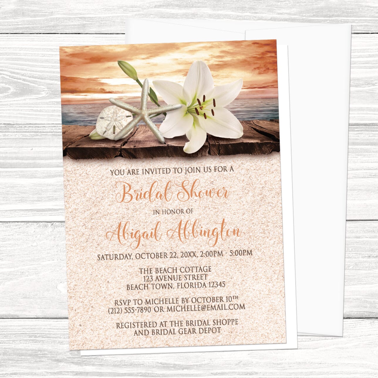 Bridal Shower invitation with an autumn beach theme, with a white envelope, laid on a light wood tabletop