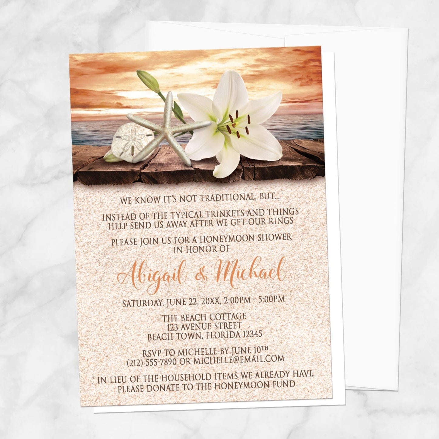 Lily Seashells and Sand Autumn Beach Honeymoon Shower Invitation shown on a marble surface with a white envelope.