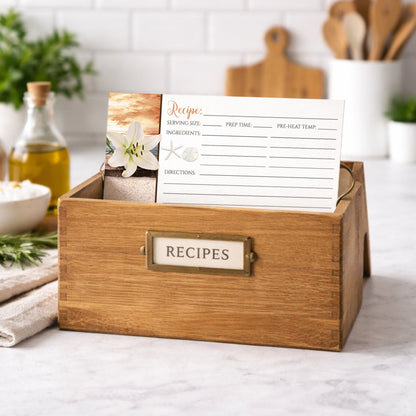 Wooden recipe box with a Lily Seashells and Sand Autumn Beach Recipe Card inside on a kitchen counter