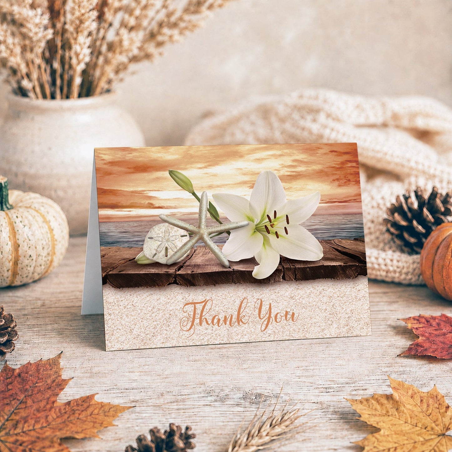 Lily Seashells and Sand Autumn Beach Thank You Card shown on a tabletop with fall leaves and autumn decor.