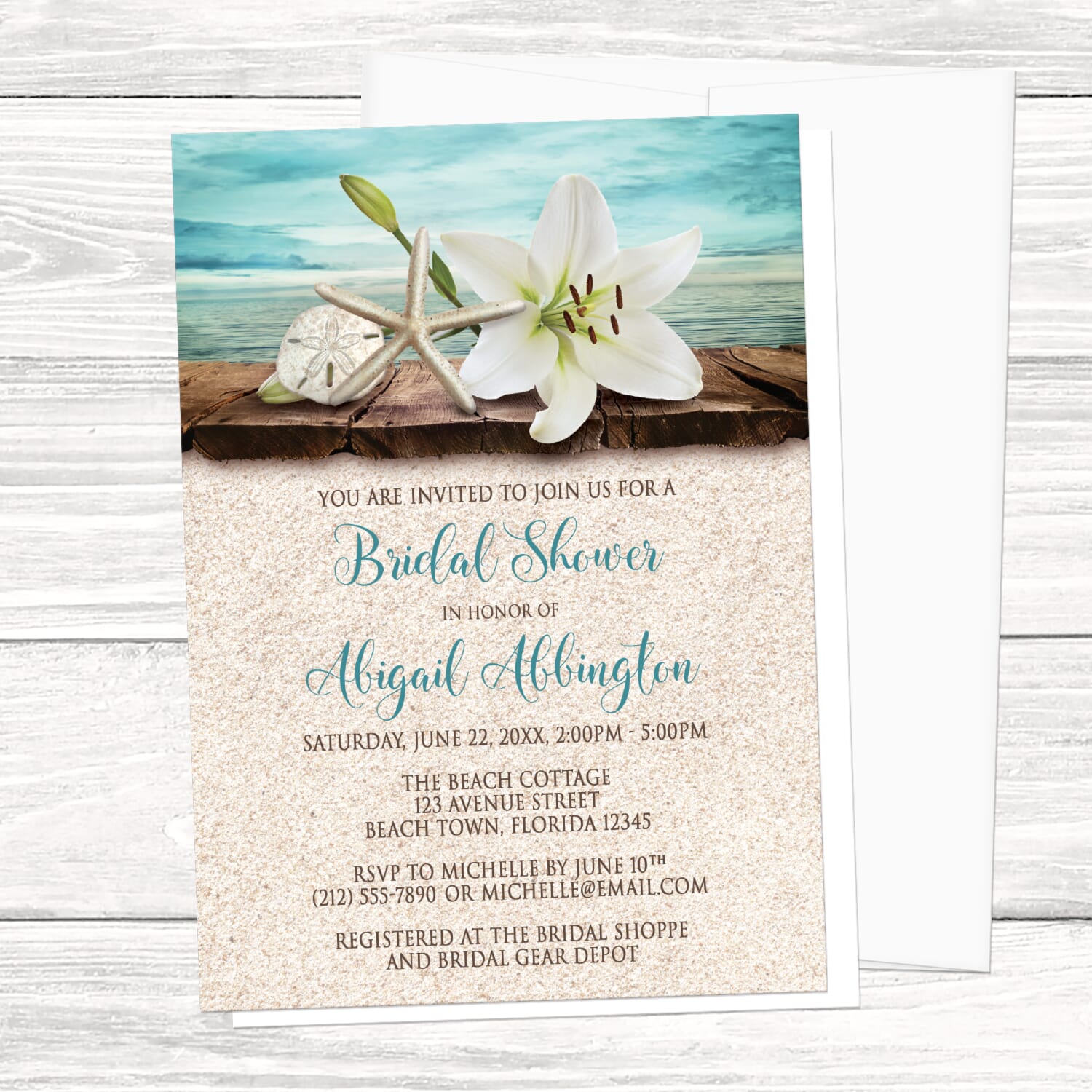 Bridal shower invitation with beach theme featuring a lily, starfish, and sand dollar on a wooden surface.