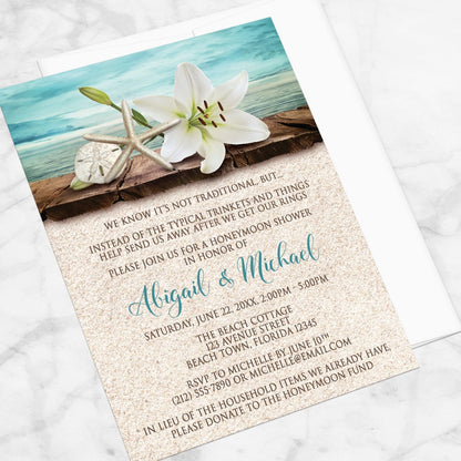 Lily Seashells and Sand Beach Honeymoon Shower Invitation shown at an angle on a marble surface with a white envelope.