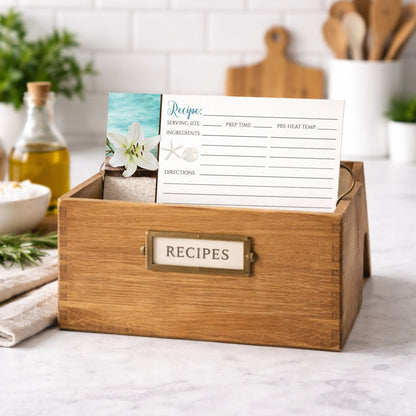 Wooden recipe box with a Lily Seashells and Sand Beach Recipe Card inside on a kitchen counter