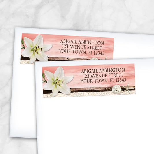 2 Lily Seashells and Sand Coral Beach Address Labels shown on white envelopes on a marble surface