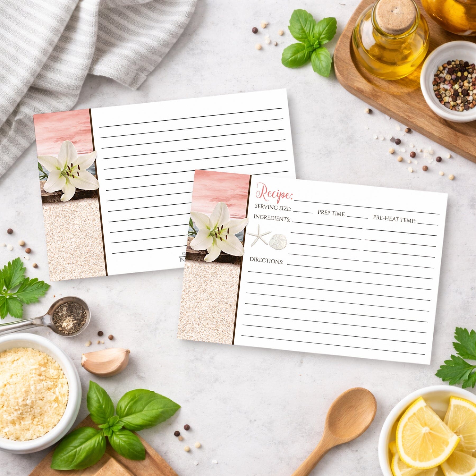 Set of Lily Seashells and Sand Coral Beach Recipe Cards on a kitchen counter with ingredients.