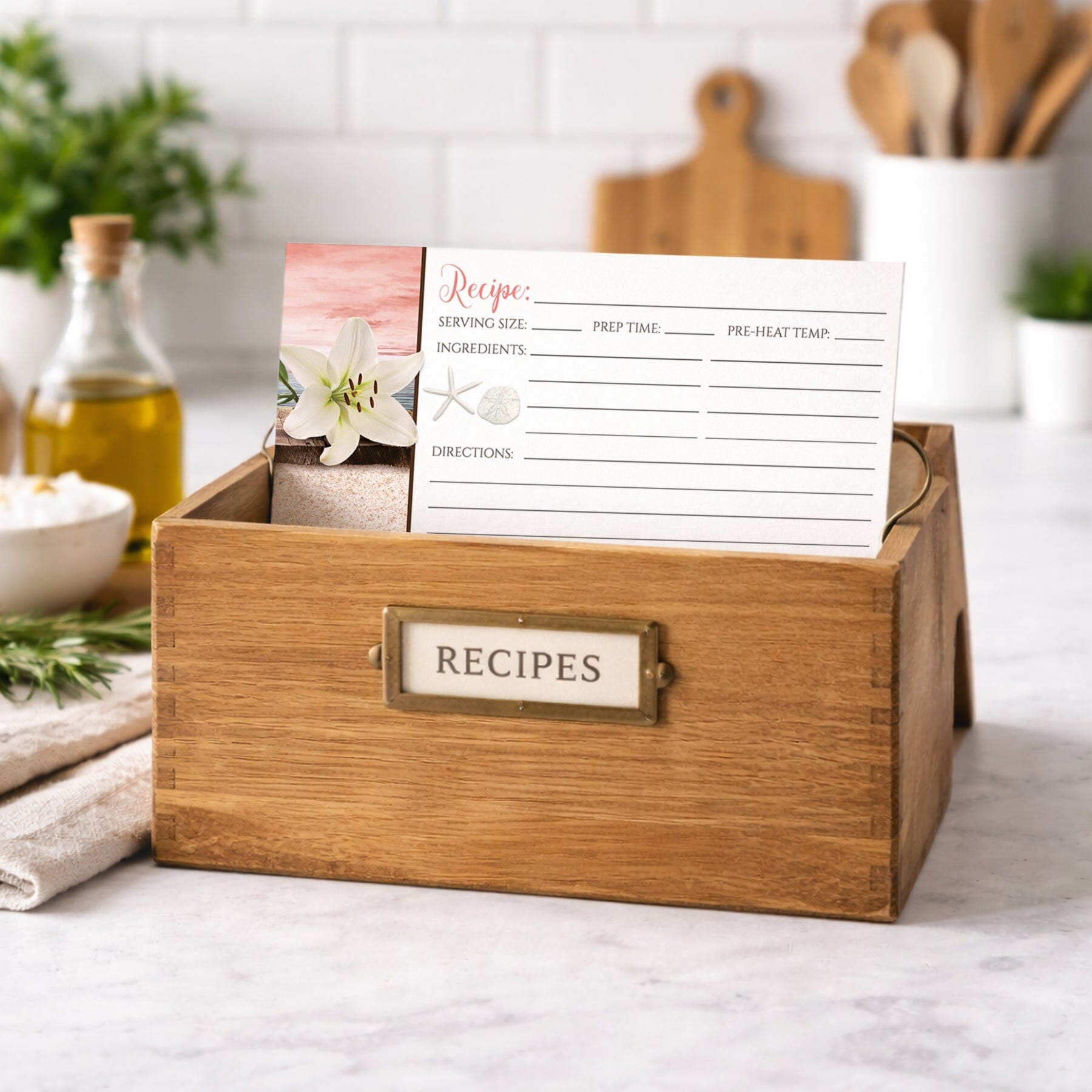 Wooden recipe box with a Lily Seashells and Sand Coral Beach Recipe Card on a kitchen counter