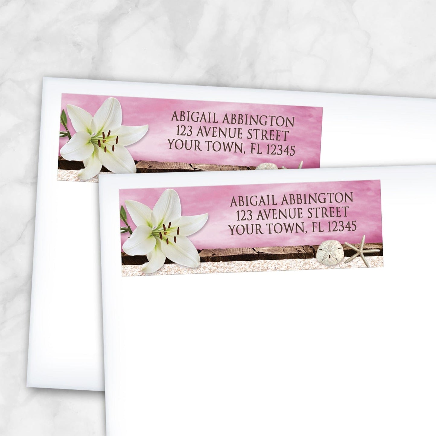 2 Lily Seashells and Sand Magenta Beach Address Labels shown on white envelopes on a marble surface