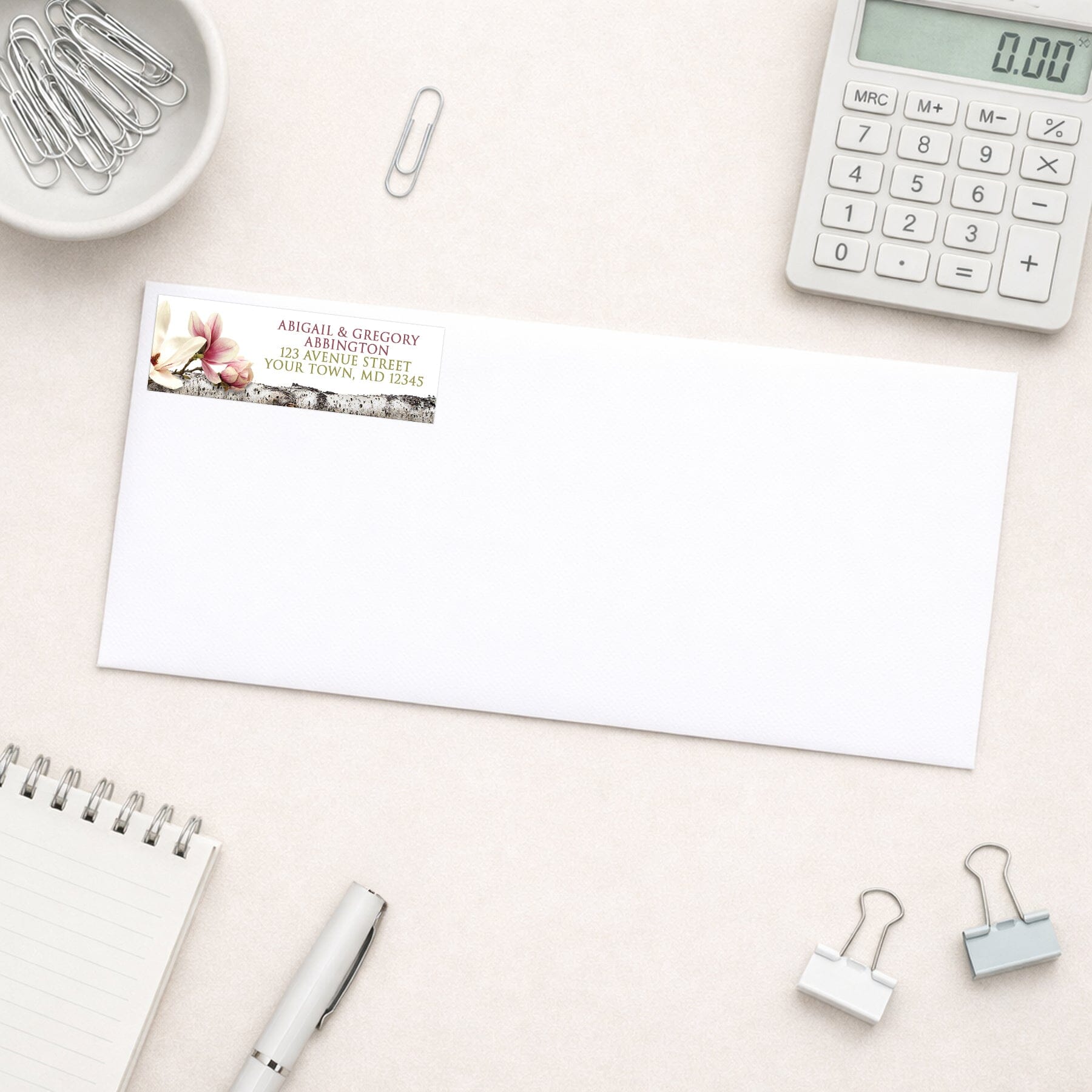 Magnolia Birch Light Floral Address Label shown on a white envelope with everyday office supplies
