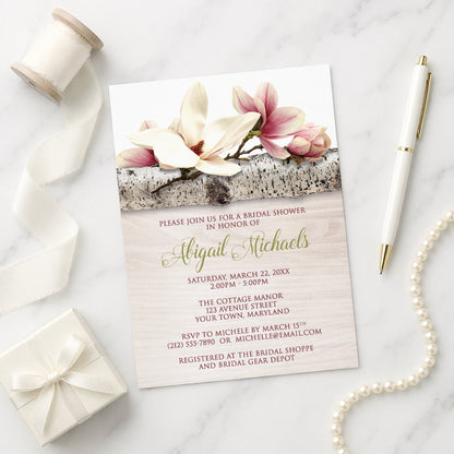 Magnolia Birch Light Wood Floral Bridal Shower Invitation on a marble surface with ribbon, gift, and pen.