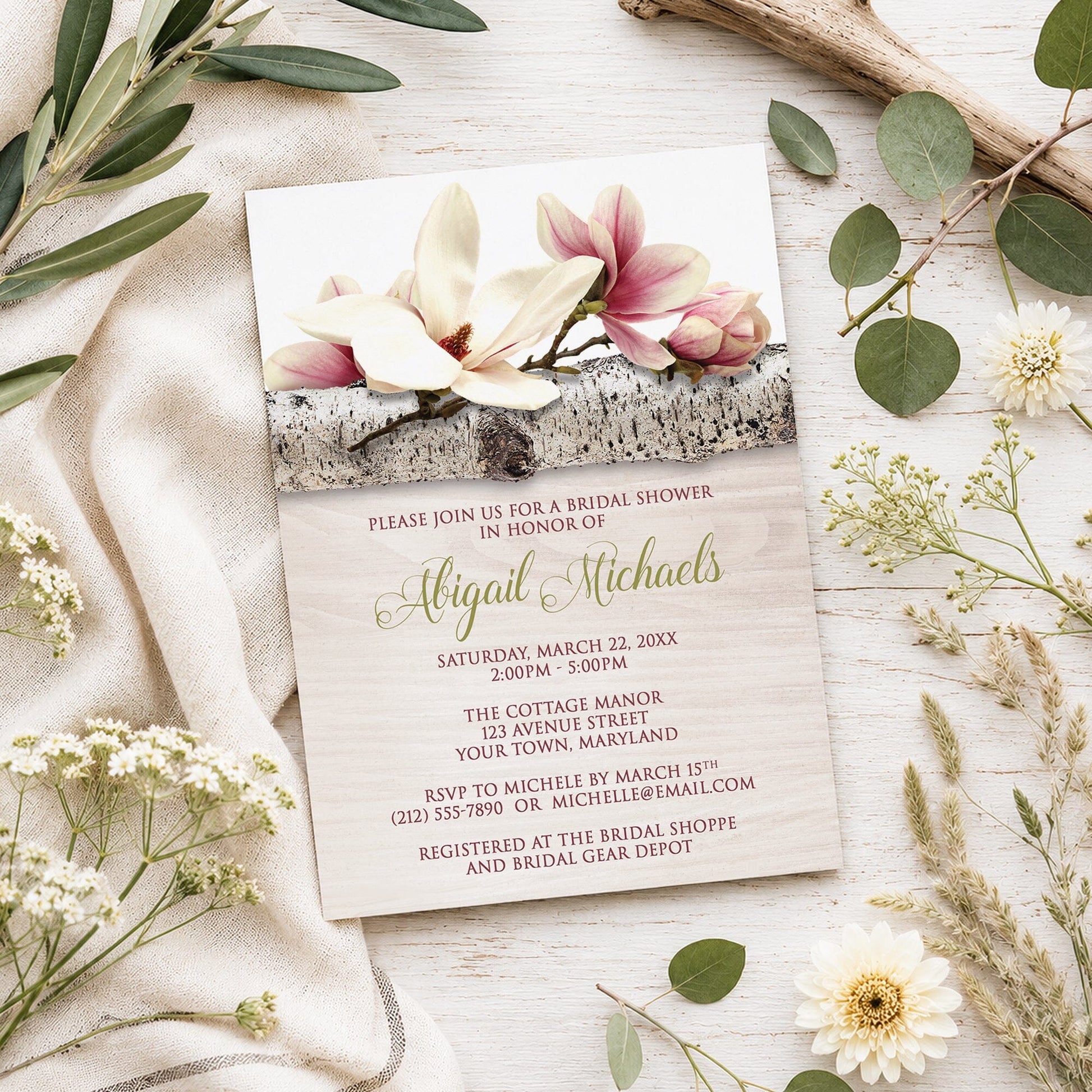 Magnolia Birch Light Wood Floral Bridal Shower Invitation shown on a light wooden surface with spring and summer plants.