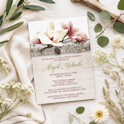 Magnolia Birch Light Wood Floral Bridal Shower Invitation shown on a light wooden surface with spring and summer plants.