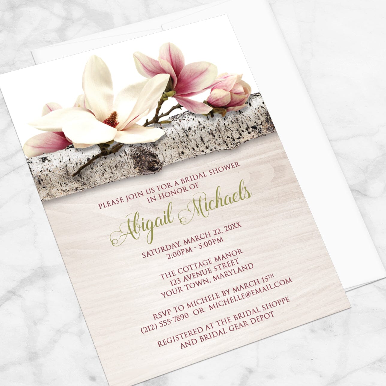 Bridal Shower invitation with a light magnolia design, on a marble tabletop