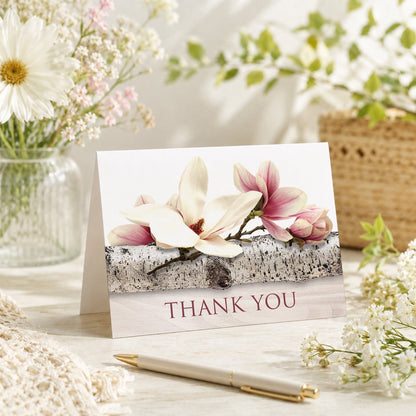 Magnolia Birch Light Wood Floral Thank You Card shown on a tabletop with a vase, spring and summer flowers, and a pen.