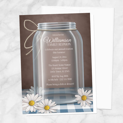 Mason Jar Daisy Blue Gingham Family Reunion Invitation shown on a marble surface with a white envelope.