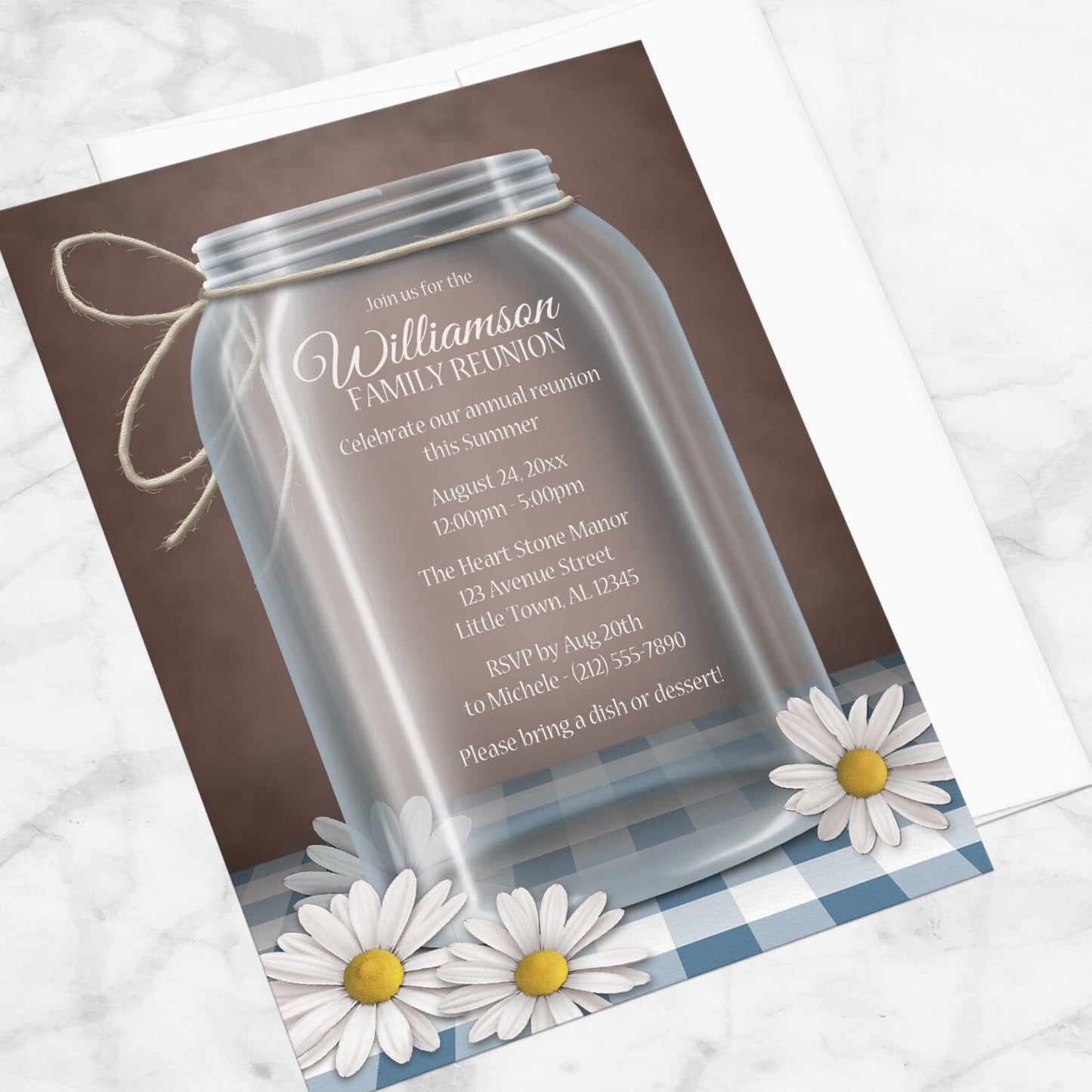 Mason Jar Daisy Blue Gingham Family Reunion Invitation shown at an angle on a marble surface with a white envelope.