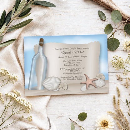 Message from a Bottle Beach Couples Shower Invitation shown on a light wooden surface with spring and summer plants.