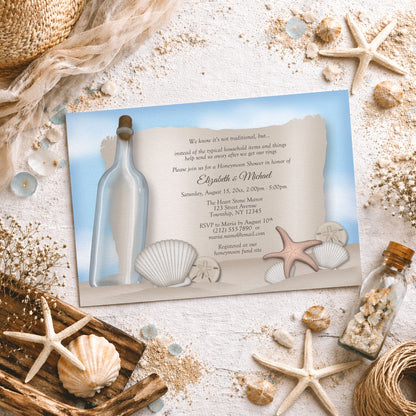 Message from a Bottle Beach Honeymoon Shower Invitation shown on a light surface with seashells, beach sand, and coastal decor.