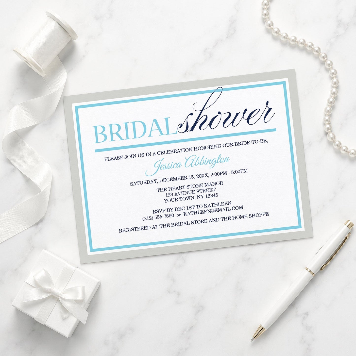 Modern Aqua Navy Gray Winter Bridal Shower Invitation on a marble surface with decorative elements.