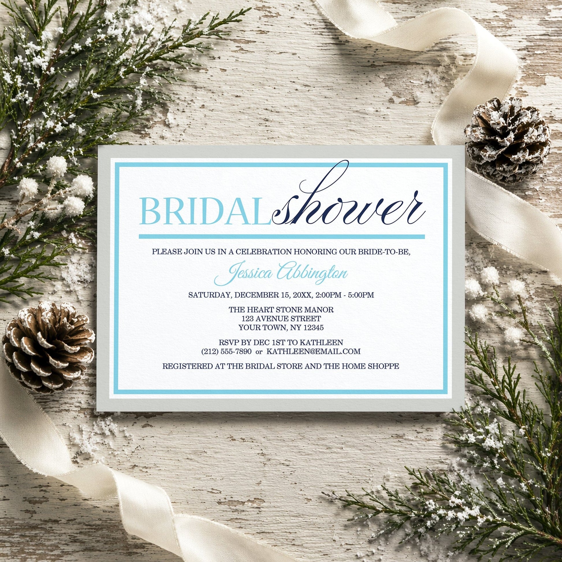 Modern Aqua Navy Gray Winter Bridal Shower Invitation on a rustic wooden surface with winter decorative elements like pine cones and ribbons.