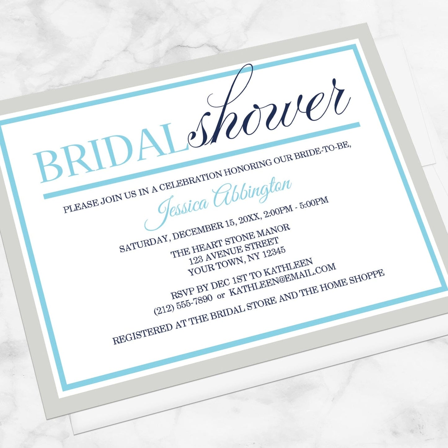 Modern Aqua Navy Gray Winter Bridal Shower Invitation shown at an angle on a marble surface with a white envelope.