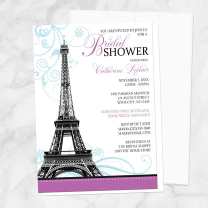 Modern Eiffel Tower Purple Parisian Bridal Shower Invitation shown on a marble surface with a white envelope.