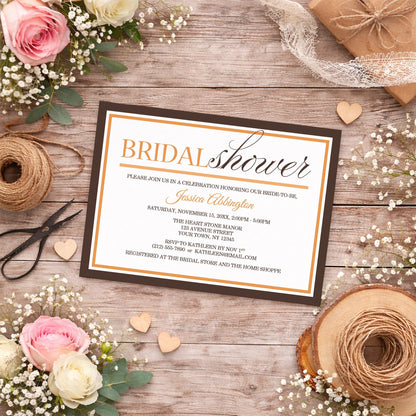 Modern Orange and Brown Autumn Bridal Shower Invitation shown on a country-style wooden surface with summer flowers, small wood hearts, and twine.