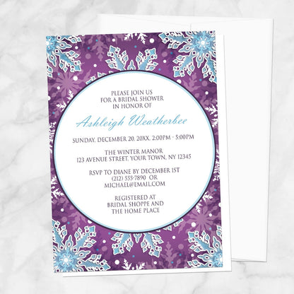 Modern Purple Blue Snowflake Bridal Shower Invitation shown on a marble surface with a white envelope.