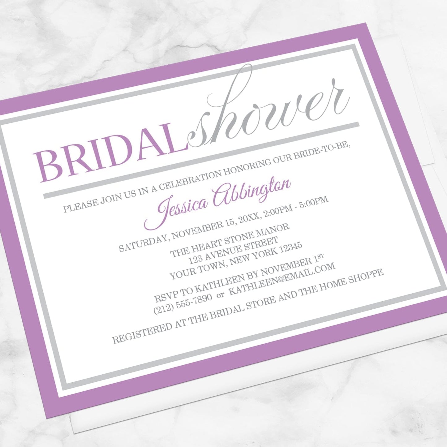 Modern Purple and Gray Bridal Shower Invitation shown at an angle on a marble surface with a white envelope.