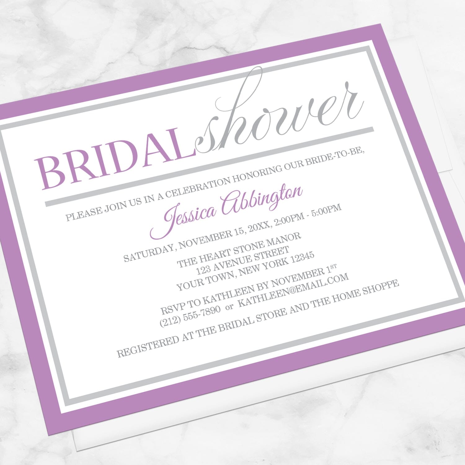 Modern Purple and Gray Bridal Shower Invitation shown at an angle on a marble surface with a white envelope.