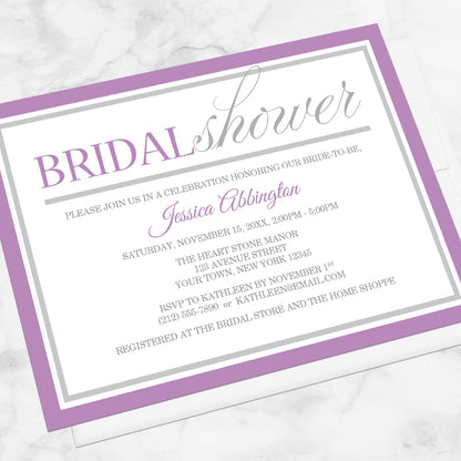 Modern Purple and Gray Bridal Shower Invitation shown at an angle on a marble surface with a white envelope.