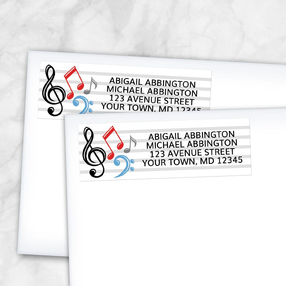 Music Notes Address Labels at Artistically Invited. Return address labels designed with red, blue, black, and gray music notes and symbols on the left side. These music notes and symbols, and your personalized return address in black, are printed over a set of 5 staff lines to continue the music theme. Example shows labels on envelopes.