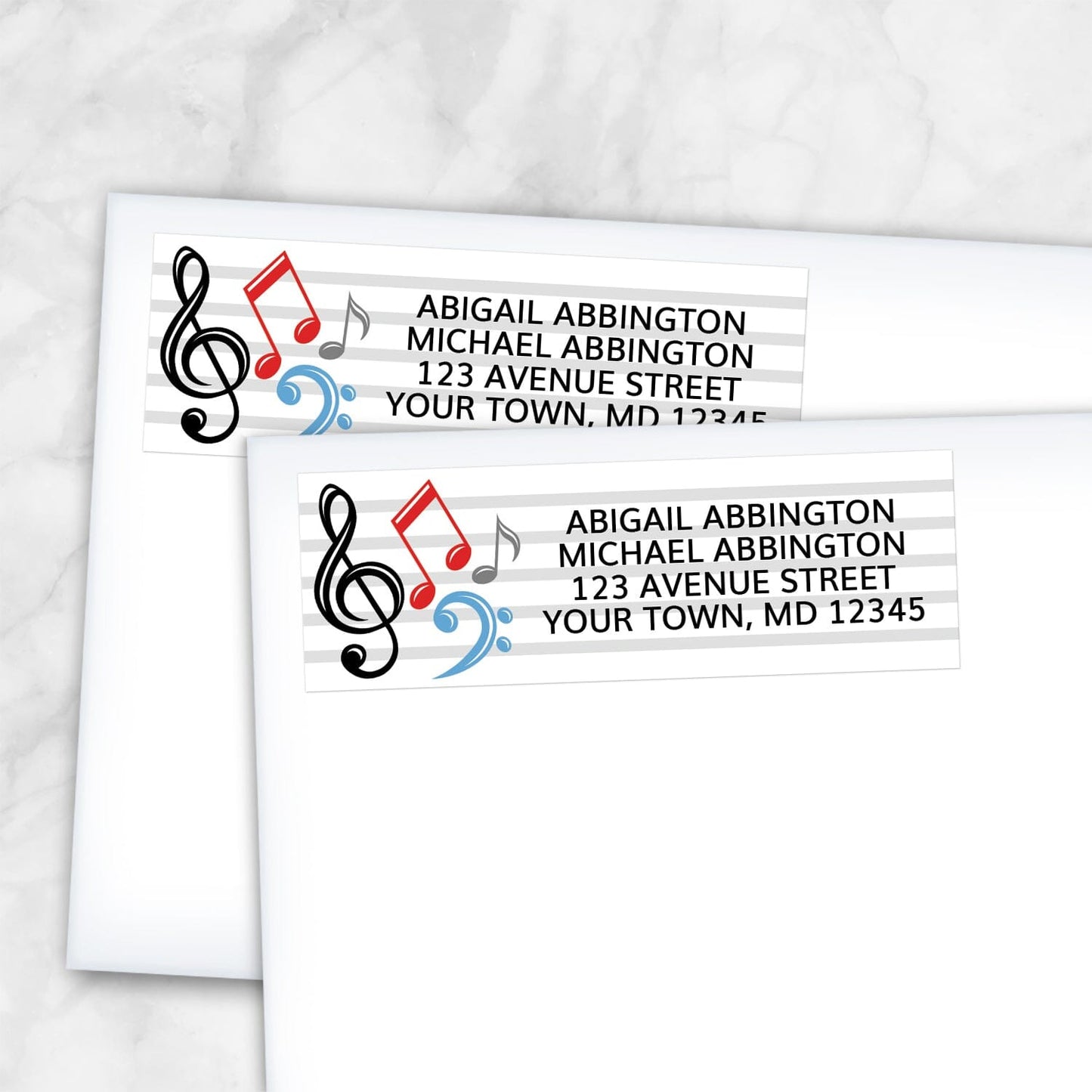 2 Music Notes Address Labels shown on white envelopes on a marble surface