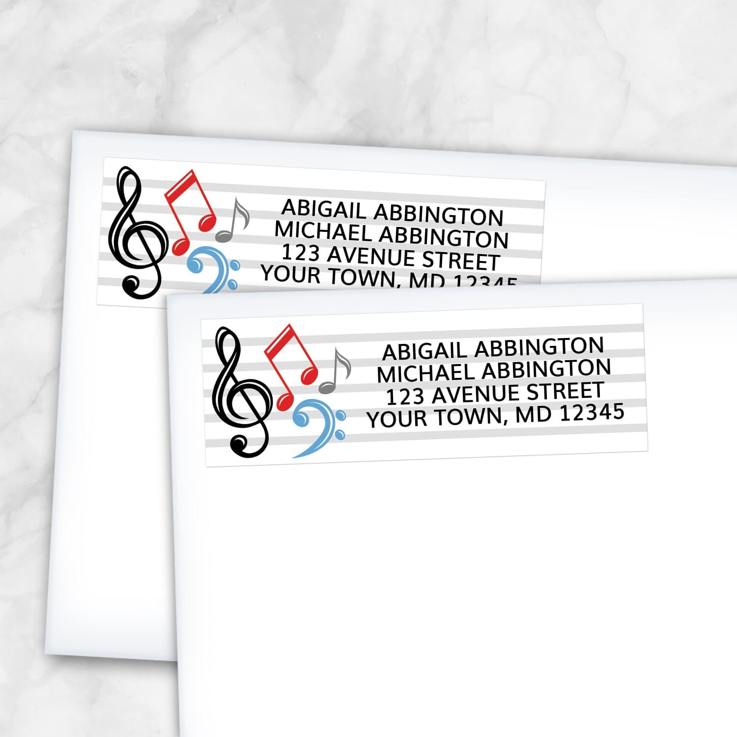 2 Music Notes Address Labels shown on white envelopes on a marble surface