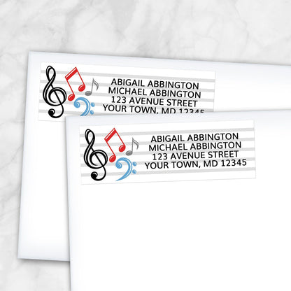 2 Music Notes Address Labels shown on white envelopes on a marble surface