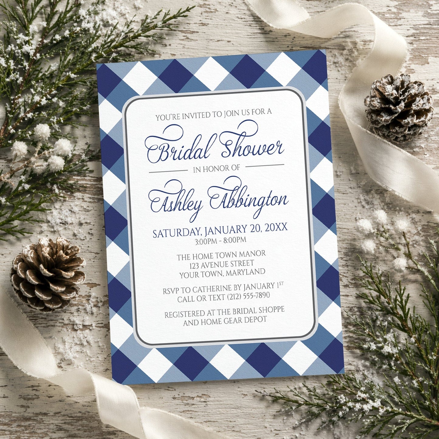 Navy Blue Gingham Bridal Shower Invitation with blue and white checkered border on a rustic wooden background with winter pine cones and ribbons.