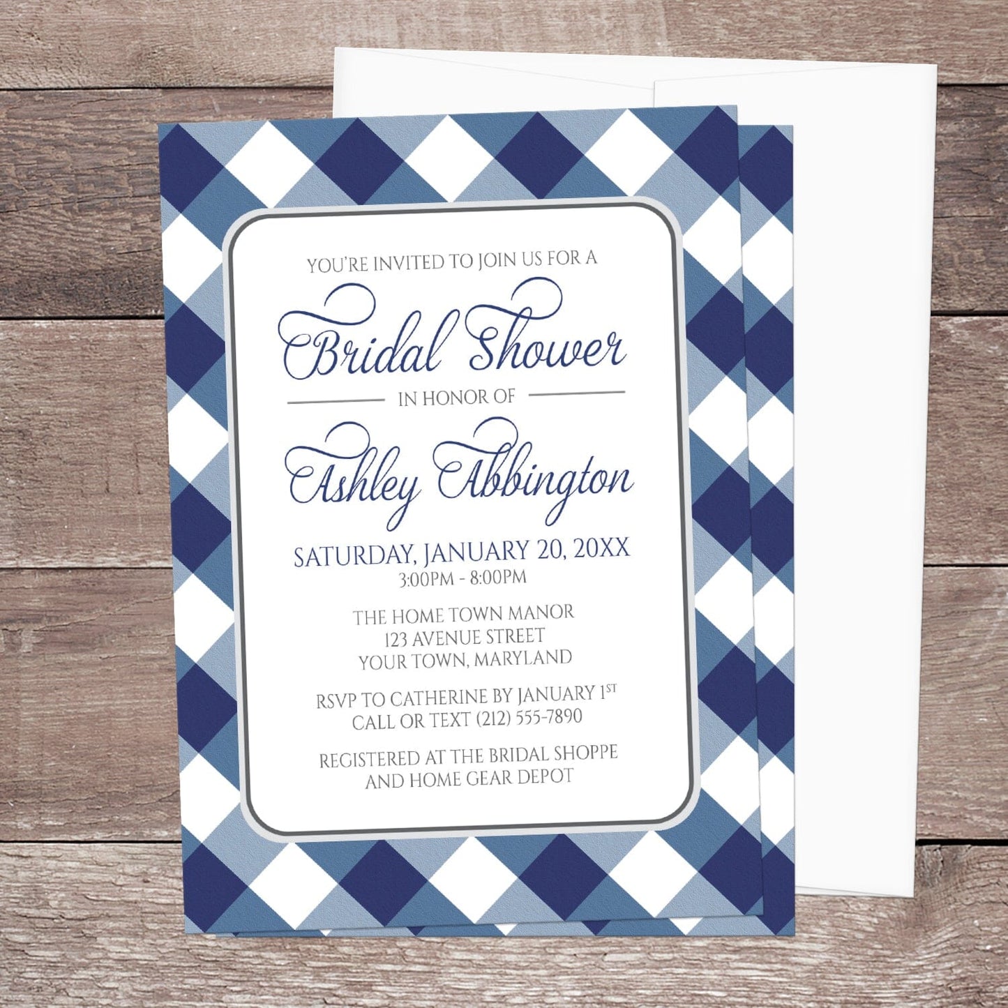 Navy Blue Gingham Bridal Shower Invitation with blue and white checkered border shown on a wooden surface with a white envelope.