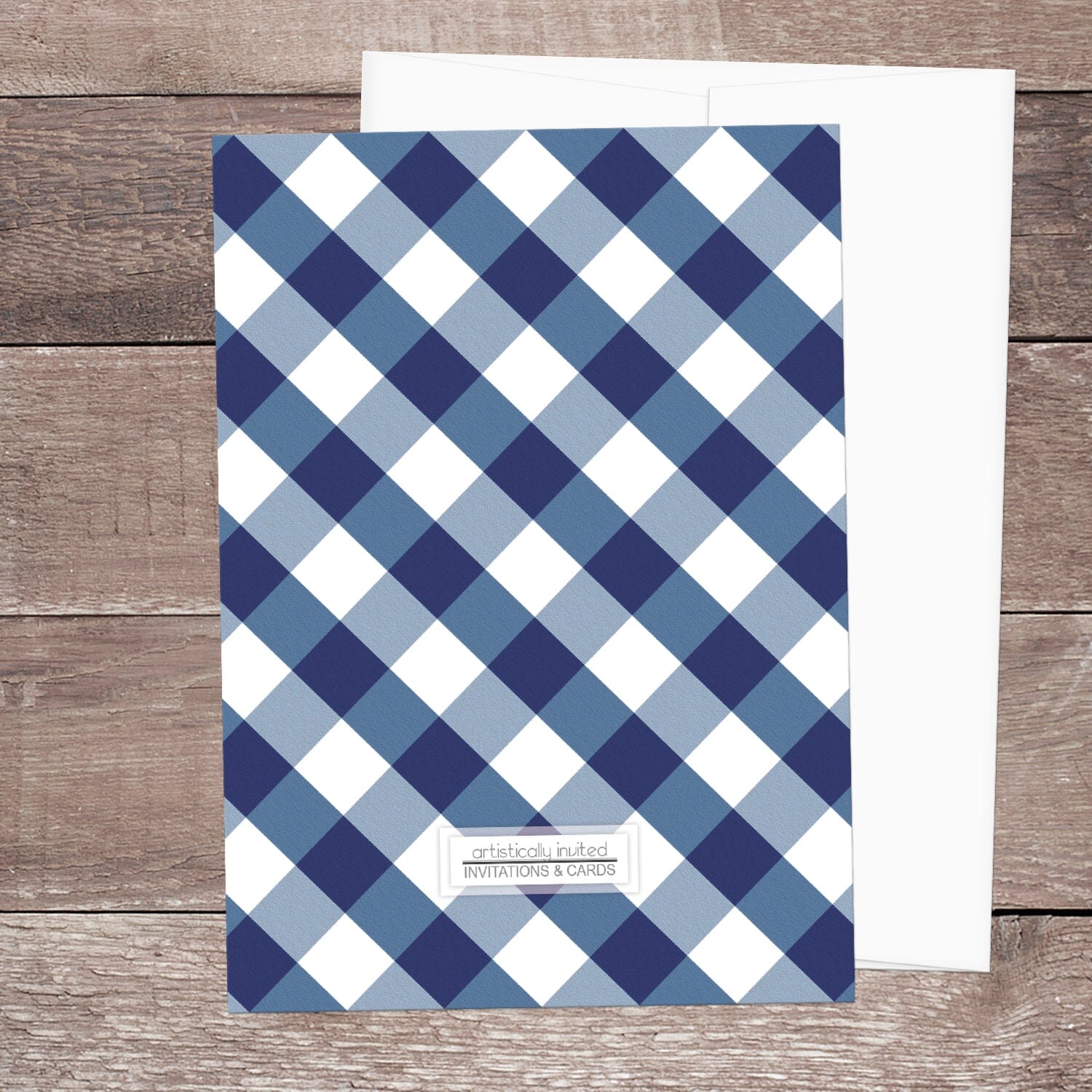 The back side of the Navy Blue Gingham Bridal Shower Invitation shown on a wooden surface with a white envelope.