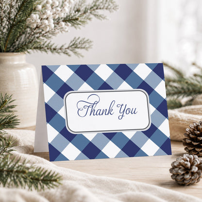 Navy Blue Gingham Thank You Card shown on a tabletop with a vase, winter greenery, and pine cones.