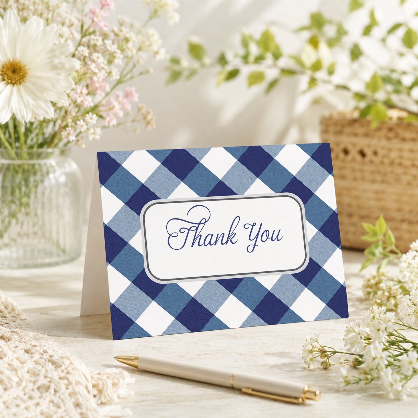 Navy Blue Gingham Thank You Card shown on a tabletop with a vase, spring and summer flowers, and a pen.