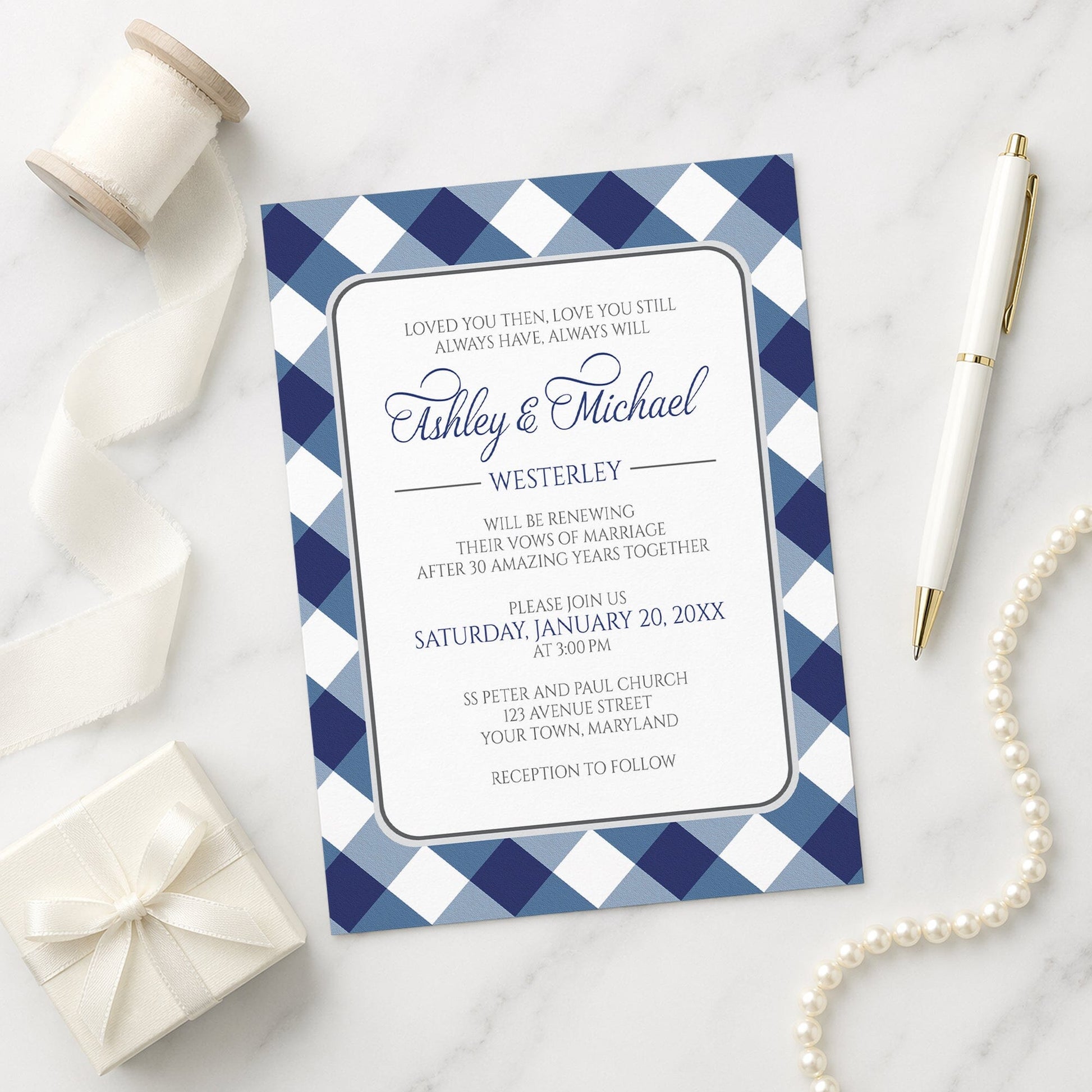 Navy Blue Gingham Vow Renewal Invitation shown on a marble surface with a white gift box, pen, ribbon, and pearls.