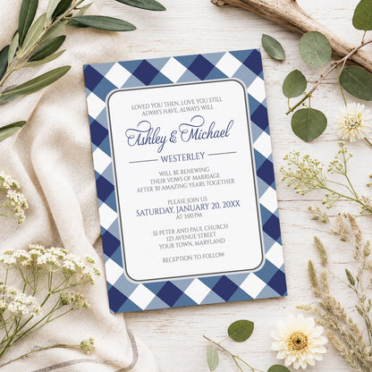 Navy Blue Gingham Vow Renewal Invitation shown on a light wooden surface with spring and summer plants.