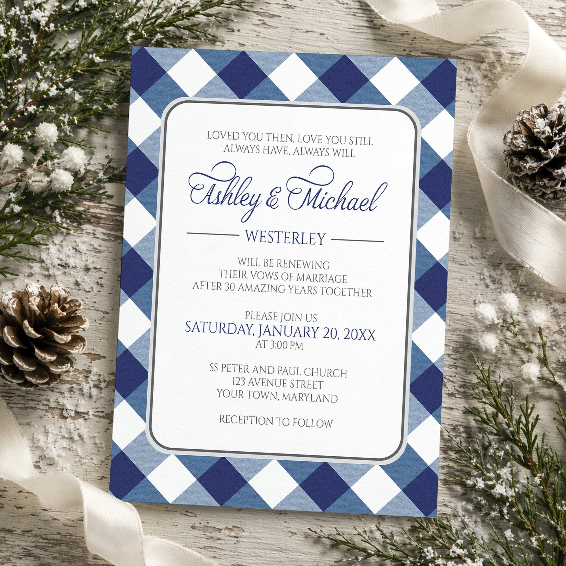 Navy Blue Gingham Vow Renewal Invitation shown on a rustic wooden surface with winter greenery, ribbons, and pine cones.