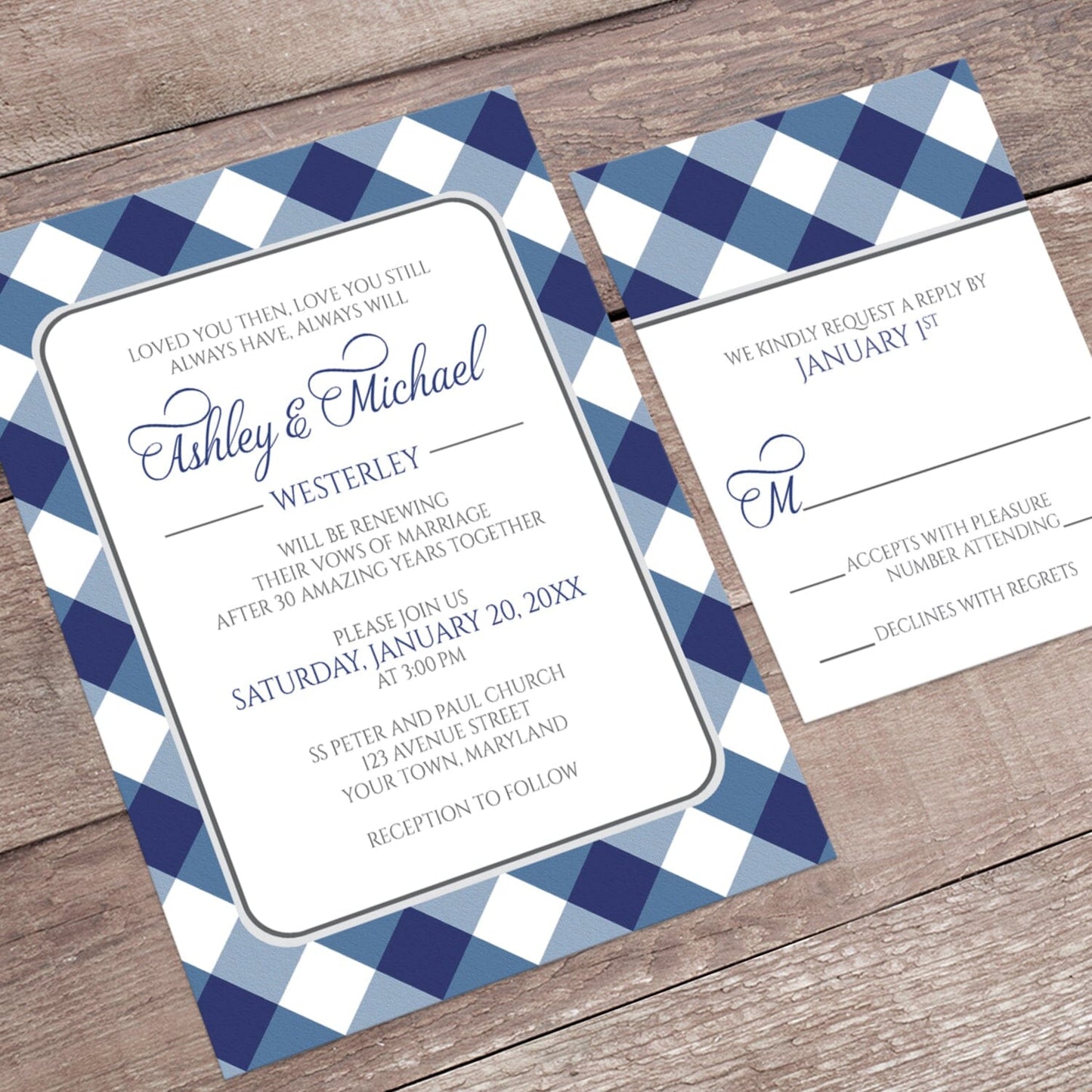Navy Blue Gingham Vow Renewal Invitation shown at an angle on a brown wooden surface with the matching RSVP card.