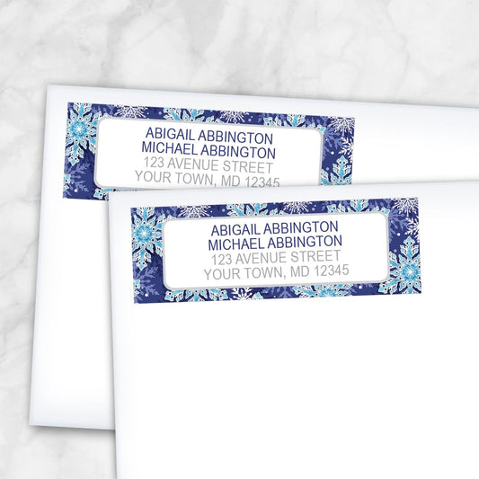 2 Navy Blue Snowflake Winter Return Address Labels shown on white envelopes on a marble surface