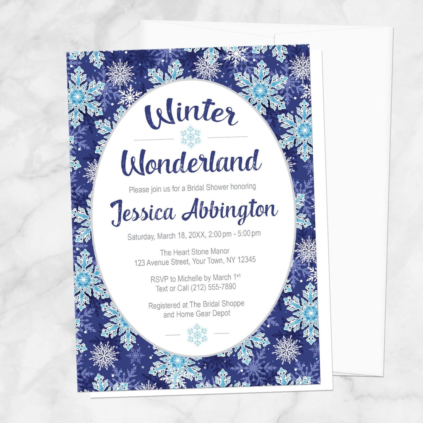 Winter Wonderland bridal shower invitation with a navy blue snowflake design shown on a marble surface with a white envelope.