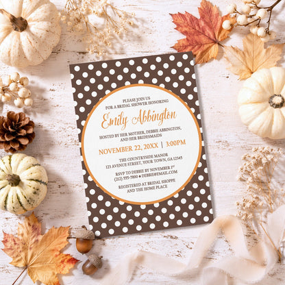 Orange Brown Polka Dot Bridal Shower Invitation on a rustic surface with autumn decorations.