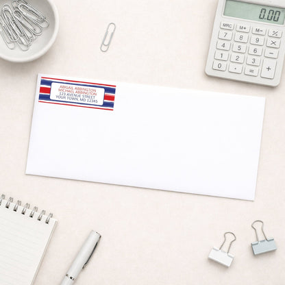 Patriotic Paint Brush Strokes Address Label shown on a white envelope on a desk with office supplies.