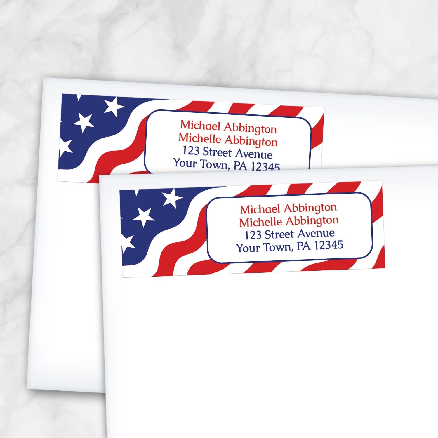 Two address labels shown on white envelopes with an American flag design on a white marble background