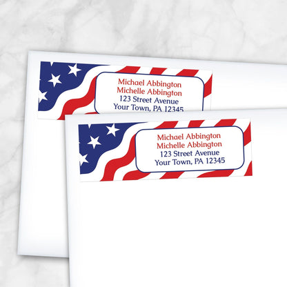 Two address labels shown on white envelopes with an American flag design on a white marble background